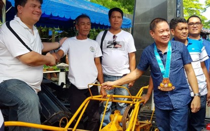 <p><strong>HELP FROM DA.</strong> Silay City Mayor Mark Golez (left) and Provincial Agriculturist Japhet Masculino (right) lead the turn-over of post-harvest facilities funded by the  bottom-up budgeting program of the Department of Agriculture (DA) during the opening of the northern Negros city’s Agri-Aqua Trade Fair on Monday (June 4, 2018). <em>(Photo contributed to PNA Bacolod)</em></p>